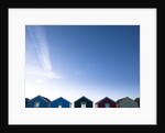 Beach huts in a row against blue skies by Assaf Frank